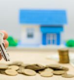 Keys and money piles and houses for mortgage loan concepts.